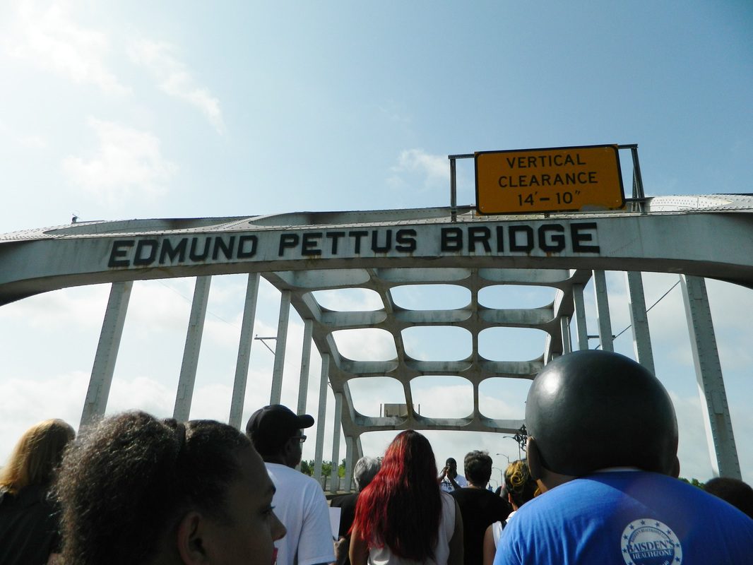 A group of people standing on top of a bridge.