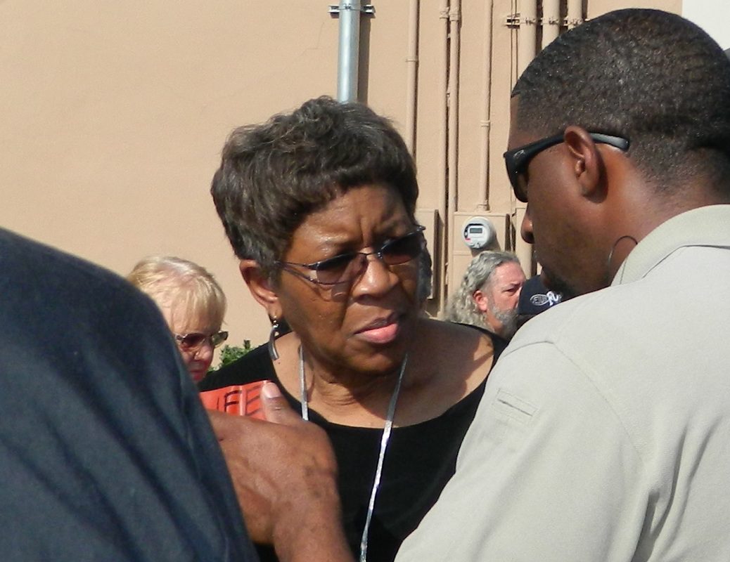 A woman with glasses is listening to music.